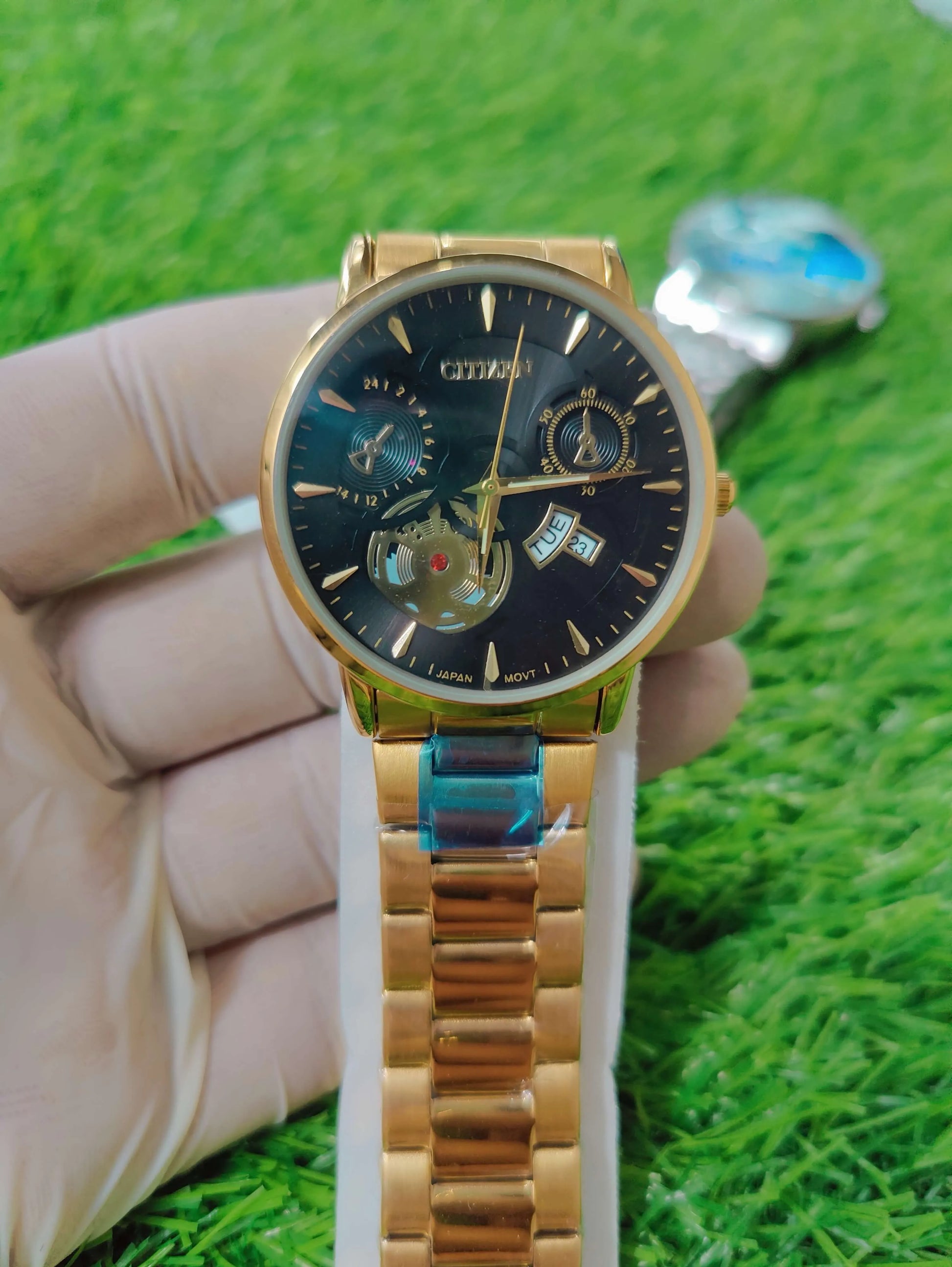 Citizen men’s black dial and gold stainless steel chain watch